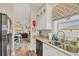Bright kitchen features granite counters, stainless steel appliances and views to living area at 10451 Sherman St, Englewood, FL 34224