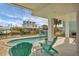 Relaxing backyard pool area with waterfront access, comfortable seating, and a stunning view of the surrounding area at 10451 Sherman St, Englewood, FL 34224