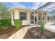 This backyard features a screened-in lanai, manicured landscaping, and a brick pathway to the home at 12650 Montigello Ct, Englewood, FL 34223