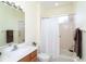 Bathroom with vanity sink, toilet, bathtub, and shower with glass door at 12650 Montigello Ct, Englewood, FL 34223