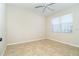 Bedroom featuring neutral walls, tile floor, and a bright window at 12650 Montigello Ct, Englewood, FL 34223