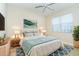 Bedroom with a queen bed, blue rug and modern decor at 12650 Montigello Ct, Englewood, FL 34223