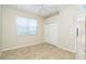 A cozy bedroom with a window letting in natural light and a closet for storage at 12650 Montigello Ct, Englewood, FL 34223
