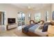 Comfortable bedroom with a ceiling fan and sliding door access to the pool area at 12650 Montigello Ct, Englewood, FL 34223