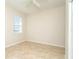 Empty bedroom with tile floors and a window at 12650 Montigello Ct, Englewood, FL 34223