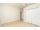This cozy bedroom is bright with neutral walls, tile floors, and has a large closet for storage at 12650 Montigello Ct, Englewood, FL 34223