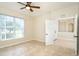 Neutral bedroom featuring tile flooring, natural light, and a ceiling fan at 12650 Montigello Ct, Englewood, FL 34223