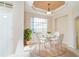 Dining area with modern chairs, table, ceiling detail and lots of natural light at 12650 Montigello Ct, Englewood, FL 34223