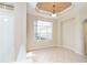 Dining area with natural light, neutral paint, tile floors, and ceiling detail at 12650 Montigello Ct, Englewood, FL 34223