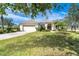 Charming single-Gathering home with a well-kept lawn, attractive landscaping, and a double-car garage at 12650 Montigello Ct, Englewood, FL 34223