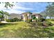 Beautiful home with a well-maintained lawn and tropical landscaping at 12650 Montigello Ct, Englewood, FL 34223