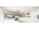 Open two-car garage featuring door leading to front yard, storage shelves, and automatic garage door at 12650 Montigello Ct, Englewood, FL 34223