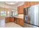 Well-appointed kitchen featuring stainless steel appliances, wooden cabinets, and an open layout at 12650 Montigello Ct, Englewood, FL 34223