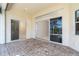 Spacious lanai featuring brick flooring and sliding glass doors that merge indoor and outdoor living at 12650 Montigello Ct, Englewood, FL 34223