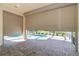 Spacious lanai area with automated roll down hurricane shutters and a view of the pool at 12650 Montigello Ct, Englewood, FL 34223