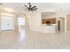 Open living area with tile flooring, natural light, and views to other rooms and entry at 12650 Montigello Ct, Englewood, FL 34223