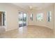 Bright living room with tile floors and sliding glass doors overlooking pool at 12650 Montigello Ct, Englewood, FL 34223