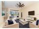 Spacious living room featuring a ceiling fan, neutral paint, and sliding door to the outdoors at 12650 Montigello Ct, Englewood, FL 34223