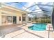 Beautiful pool and lanai with clear blue water, covered patio, and ample outdoor space for relaxation at 12650 Montigello Ct, Englewood, FL 34223
