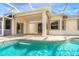 Tranquil backyard pool featuring a serene view of the water, lanai and beautiful outdoor living space at 12650 Montigello Ct, Englewood, FL 34223