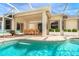 Covered patio next to a pool with ample outdoor seating at 12650 Montigello Ct, Englewood, FL 34223