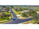 Neighborhood street view of a charming single-Gathering home with a well-manicured lawn and sidewalk at 12650 Montigello Ct, Englewood, FL 34223