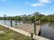 Private wooden dock with boat lift providing direct access to the serene waterfront at 2295 Chilcote Ter, Port Charlotte, FL 33981