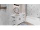 Bright bathroom with tub and shower, white cabinets, and lovely lighting for a fresh, clean feel at 254 Mark Twain Ln, Rotonda West, FL 33947