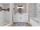 Beautiful bathroom with white cabinets, double sinks, and a walk-in shower and tub at 254 Mark Twain Ln, Rotonda West, FL 33947
