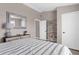 Comfortable bedroom with soft lighting, a large mirror, and ample storage space at 254 Mark Twain Ln, Rotonda West, FL 33947