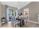 Bright dining area with modern furniture and a view of the outdoor pool at 254 Mark Twain Ln, Rotonda West, FL 33947