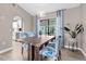 Elegant dining room features stylish chairs, a modern light fixture, and sliding glass door to the lanai at 254 Mark Twain Ln, Rotonda West, FL 33947
