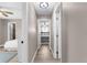 Hallway view with bedrooms on both sides, featuring modern ceiling fans at 254 Mark Twain Ln, Rotonda West, FL 33947