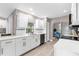 White cabinets and countertop in a lovely bright kitchen, overlooking the dining area at 254 Mark Twain Ln, Rotonda West, FL 33947