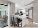 A modern kitchen with a bar top overlooking an outdoor living space at 254 Mark Twain Ln, Rotonda West, FL 33947