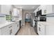Bright kitchen featuring white cabinets, stainless steel appliances, and gold hardware at 254 Mark Twain Ln, Rotonda West, FL 33947