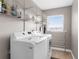 Functional laundry room with modern washer and dryer, plus ample shelving at 254 Mark Twain Ln, Rotonda West, FL 33947