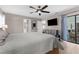 Spacious main bedroom with a ceiling fan, dresser, and a view of the lanai at 254 Mark Twain Ln, Rotonda West, FL 33947