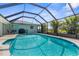Inviting screened-in pool featuring bright blue water, tiled trim, and surrounding greenery at 254 Mark Twain Ln, Rotonda West, FL 33947