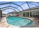 Sparkling screened-in pool with ample space for seating and entertaining outdoors at 254 Mark Twain Ln, Rotonda West, FL 33947