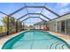 Screened pool with lounge chairs and easy access to the yard, perfect for relaxation at 254 Mark Twain Ln, Rotonda West, FL 33947