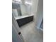 Bathroom featuring gray vanity with double sinks, large mirror, and tile flooring at 2814 Vogler Ln, North Port, FL 34286