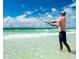 A Personal fishing on a white sand beach enjoying the beautiful ocean scenery at 2814 Vogler Ln, North Port, FL 34286