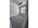 Bedroom with neutral walls, plush carpeting, ceiling fan and a window with natural light at 2814 Vogler Ln, North Port, FL 34286