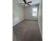 Cozy bedroom with neutral walls, plush carpeting, and a window with natural light at 2814 Vogler Ln, North Port, FL 34286