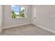 Neutral-toned bedroom with a large window offering natural light and views at 2814 Vogler Ln, North Port, FL 34286