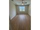Spacious bedroom with wood-look flooring and natural light at 2814 Vogler Ln, North Port, FL 34286