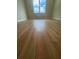 Bedroom with wood-look flooring and abundant natural light at 2814 Vogler Ln, North Port, FL 34286