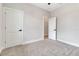 Bedroom with a neutral color scheme, soft carpeting, and doors leading to a hallway at 2814 Vogler Ln, North Port, FL 34286