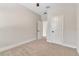 Bright bedroom with neutral walls, plush carpet, white trim, and contemporary ceiling fan at 2814 Vogler Ln, North Port, FL 34286